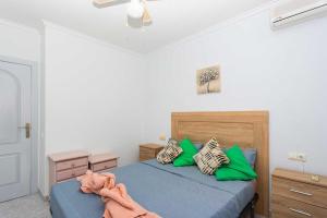 a bedroom with two beds with green pillows at CH Buganvillas Ciudad Quesada in Ciudad Quesada +25 photos