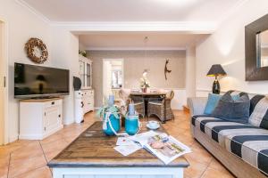 a living room with a couch and a table at Haus Bötticher Straße Whg 01 in Westerland (Sylt)