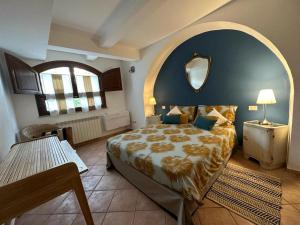 a bedroom with a large bed and a mirror at La Casa di Filippo in Quercianella