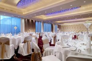 a banquet hall with white tables and chairs at Sheraton Athlone Hotel in Athlone