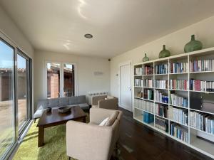 a living room with a book shelf filled with books at Casa Albons by Costabravaway in Albóns
