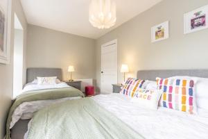 a bedroom with two beds and a chandelier at Historic Hideaway Waterford City in Waterford