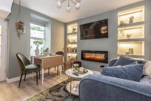 a living room with a blue couch and a table at Historic Hideaway Waterford City in Waterford