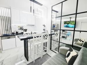 a white kitchen with a table and a couch at Kemer Classic Apartments in Kemer