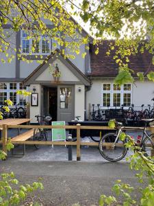 a picnic table with a bike parked in front of a building at The Queen Stage in Effingham