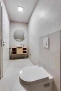 a bathroom with a white toilet and a sink at Villa Endless Summer in Sveti Anton