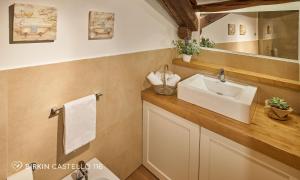 a bathroom with a sink and a mirror at Albergo Diffuso Birkin Castello in Cagliari