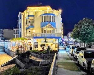 a building with cars parked in front of it at night at CASA DEL SOL Sozopol in Sozopol