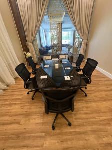 a conference room with a table and chairs and a couch at Smayah Hotel in Riyadh