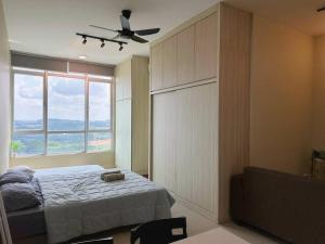 een slaapkamer met een bed en een groot raam bij JB City Sunset Studio Paradigm Sutera & UTM Wifi 4pax in Johor Bahru
