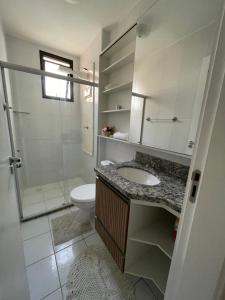 a bathroom with a sink and a toilet and a shower at Belíssimo apartamento inteiro in Aracaju