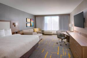 a hotel room with a bed and a desk at TownePlace Suites by Marriott Los Angeles LAX/Hawthorne in Hawthorne