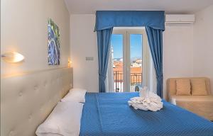 Postel nebo postele na pokoji v ubytování Hotel Caribe