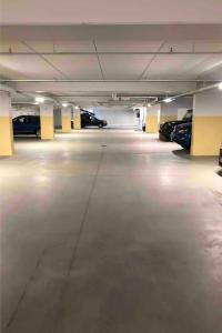 an empty parking garage with cars parked in it at Riddertunet apartment 104 - in the center of Beitostølen in Beitostøl