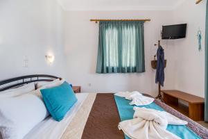 a bedroom with two beds with towels on them at Nikoleta Studio 2 in Nikiana