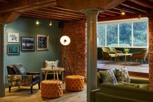 a living room with furniture and a brick wall at Manchester Marriott Victoria & Albert Hotel in Manchester