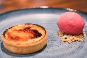 a dessert on a blue plate with a red dessert at Manchester Marriott Victoria & Albert Hotel in Manchester
