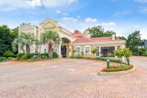 a large house with a brick driveway at Mercure Johannesburg Midrand in Midrand