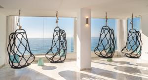 a room with two hanging lights with a view of the ocean at Hotel Benalma Costa del Sol in Benalmádena