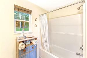 a bathroom with a shower and a bath tub at Seal Rock Cottage in Brinnon +42 photos