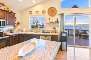 a kitchen with a table and a view of the ocean at Seal Rock Cottage in Brinnon