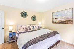 a bedroom with a bed and a painting on the wall at Seal Rock Cottage in Brinnon