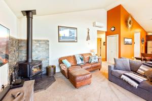 a living room with a couch and a fireplace at Seal Rock Cottage in Brinnon
