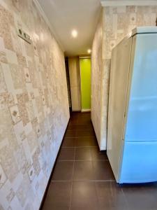 a hallway with a refrigerator in a room at Квартира на Воскресенці, поруч метро Лівобережна, Інститут Серця, МВЦ in Kyiv