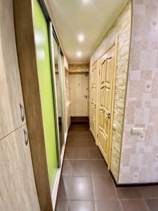 a walk in closet with green walls and wooden doors at Квартира на Воскресенці, поруч метро Лівобережна, Інститут Серця, МВЦ in Kyiv