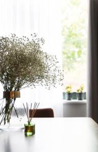 a vase of flowers sitting on a table next to a window at Oxford Street Fitzrovia Apartments in London