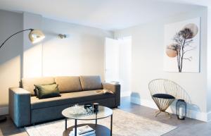 a living room with a couch and a table at Oxford Street Fitzrovia Apartments in London