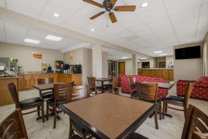a dining room with tables and chairs and a kitchen at Quality Inn Jefferson at I-85 in Jefferson