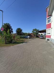 a parking lot in front of a building at Zimmer "Türkis" in Lahr-Dinglingen