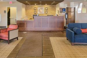 a lobby with two chairs and a reception desk at Comfort Inn & Suites Watford City in Watford City