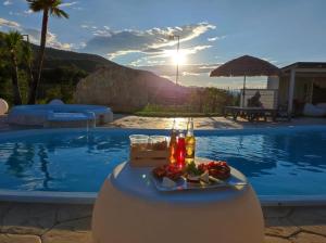 a tray of food sitting on a table next to a pool at I-relais b&b in Montefalcone del Sannio