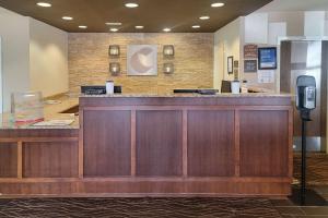 a lobby with a large wooden bar in a hospital at Comfort Inn & Suites Watford City in Watford City