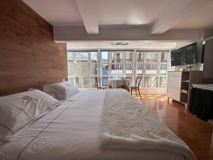 a large bed in a room with a large window at Alojamiento Luz de Hadas in Sampil +122 photos