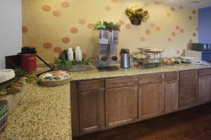 a kitchen with a counter with food on it at Americas Best Value Inn Waco - Franklin Avenue in Waco