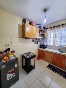 a kitchen with a stove and a counter top at 1 BR, TreasureTree Homes, Thika in Thika