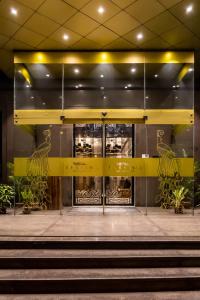 a front door of a building with stairs in front at Barsana Boutique Hotel - Pure vegetarian in Kolkata