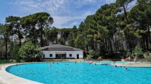 a group of people in a large swimming pool at Casa Rural La Chistera in Ávila