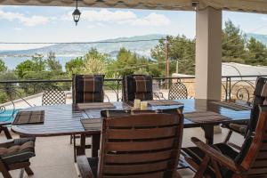 a table and chairs on a patio with a view at NisoVillas in Volos