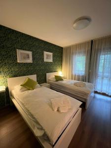 a bedroom with two beds and a window at Belvedere da Cesarina in Tarvisio