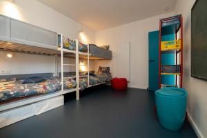 a room with two bunk beds and a blue trash can at Spacious family flat near the beach (6-8 pers) in Koksijde +23 photos