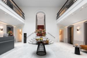 a lobby with a table with food on it at Áurea Casa Palacio Sagasta by Eurostars Hotel Company in Cádiz