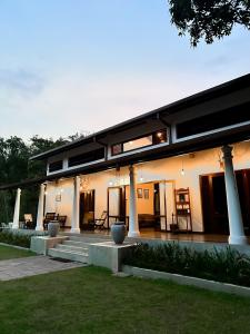 ein Haus mit Säulen und einer Treppe davor in der Unterkunft Leaf Watagala in Avissawella