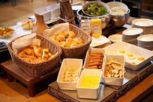 a buffet with baskets of food on a table at Hotel Sunroute Ginza in Tokyo