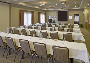 una sala de conferencias con mesas, sillas y una pantalla en Eastgate Hotel - BW Signature Collection en Bellevue