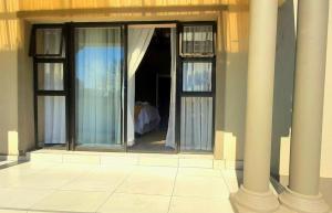 a building with two windows and two columns at The Dream Guesthouse in Ermelo