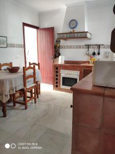 a kitchen with a table and a dining room at VILLA LOS GALLOS in Chiclana de la Frontera